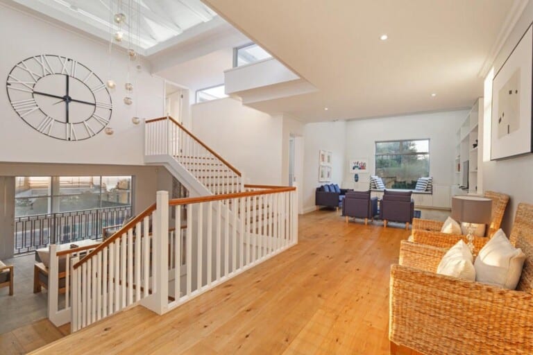 Bright open-plan interior with hardwood floors and staircase — Best for Events and Conferences
